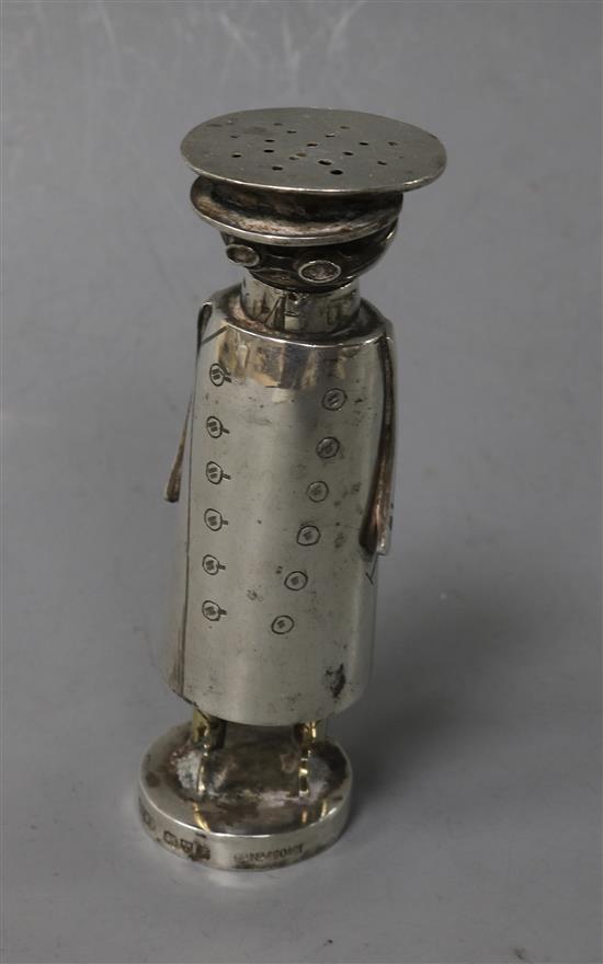 An Edwardian novelty silver pepperette in the form of a motorist, Saunders & Shepherd, 85mm.